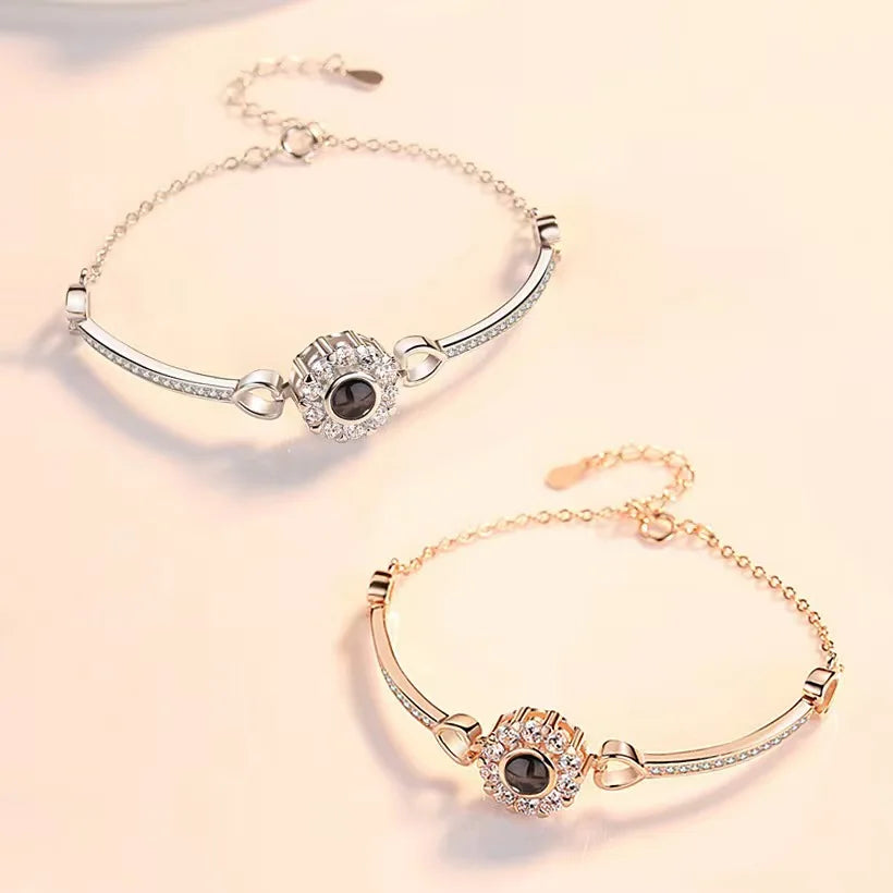 Silver and rose gold personalized photo bracelets with crystal flower centers and heart links